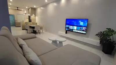 a living room with a couch and a flat screen tv at Minimalist Heaven Near Tmn Intan in Sungai Petani