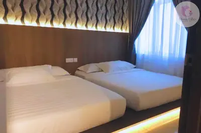 two beds in a hotel room with a window at The Majestic Condo Ipoh Home Fairy 3 in Ipoh