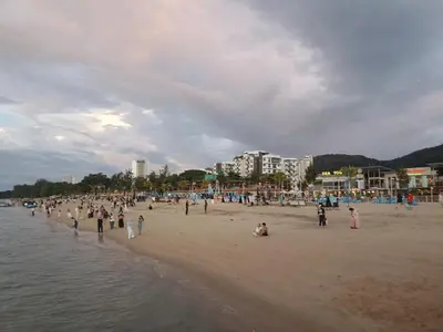 a group of people standing on a beach at Sri sayang pearl view in Batu Ferringhi