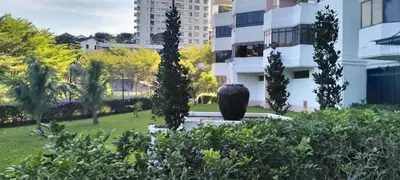 a sculpture in a park with trees and buildings at Sri sayang pearl view in Batu Ferringhi