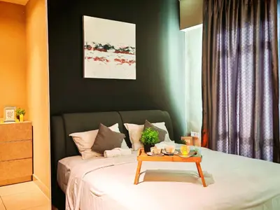 a bedroom with a bed with a table on it at Ipoh Majestic 2 Bedrooms 4Pax Modern Apartment by City Home Empire in Ipoh
