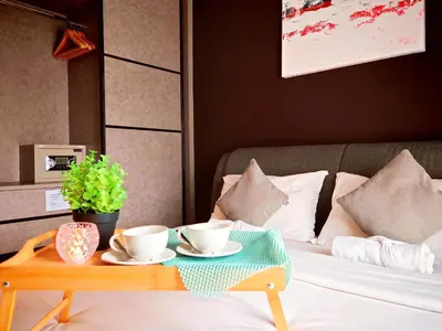 a coffee table with two cups on a bed at Ipoh Majestic 2 Bedrooms 4Pax Modern Apartment by City Home Empire in Ipoh