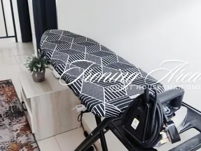 a black and white chair with a surfboard on it at Guest House Iman Umi Bagan Serai in Bagan Serai