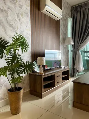 a living room with a tv and a potted plant at JS Ipoh Homestay 2 At The Majestic Ipoh in Ipoh