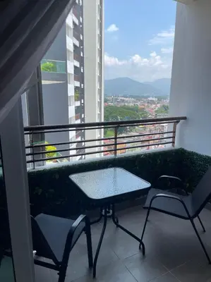 a table and chairs on a balcony with a view at JS Ipoh Homestay 2 At The Majestic Ipoh in Ipoh