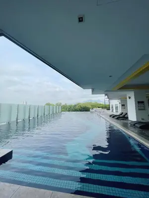 a swimming pool with a view of the water at JS Ipoh Homestay 2 At The Majestic Ipoh in Ipoh