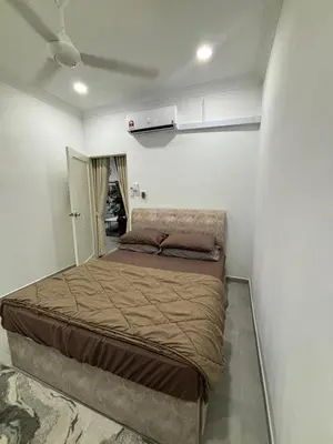 a bedroom with a large bed in a room at Idaman Cottage Sekinchan in Tanjung Karang