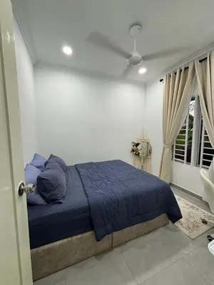a bedroom with a blue bed and a window at Idaman Cottage Sekinchan in Tanjung Karang