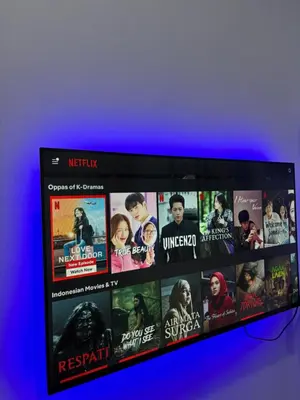 a television screen with a bunch of movies on it at Idaman Cottage Sekinchan in Tanjung Karang