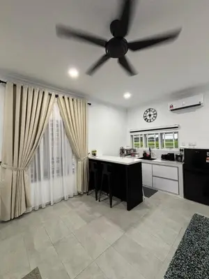 a kitchen with a ceiling fan and a counter at Idaman Cottage Sekinchan in Tanjung Karang
