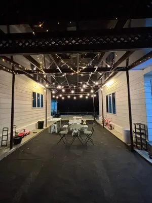 a large room with a table and chairs in it at Idaman Cottage Sekinchan in Tanjung Karang