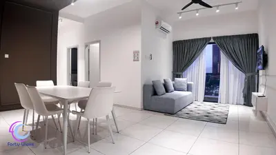 a dining room with a table and chairs and a couch at The Horizon Ipoh by 40 Winks in Ipoh