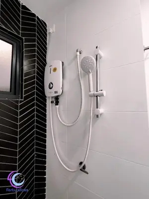 a shower in a bathroom with a hair dryer at The Horizon Ipoh by 40 Winks in Ipoh