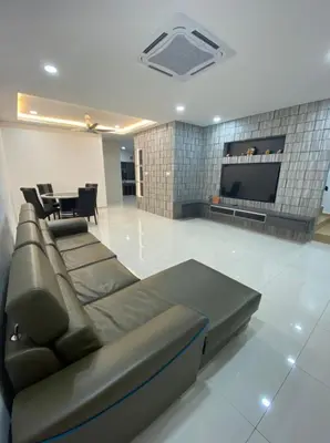a living room with a couch and a flat screen tv at L26 happy homestay in Kampong Sungai Udang