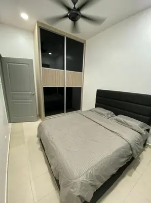 a bedroom with a bed with a ceiling fan at L26 happy homestay in Kampong Sungai Udang