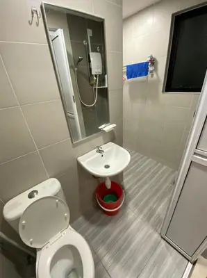 a small bathroom with a toilet and a sink at L26 happy homestay in Kampong Sungai Udang