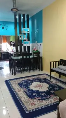 a dining room with a table and a rug at Sinakhan Homestay in Gua Musang