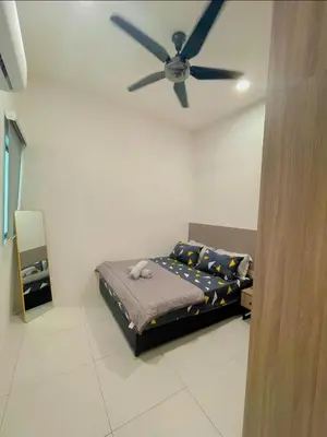 a bedroom with a bed with a ceiling fan at Hidden Plan Homestay in Kepala Batas