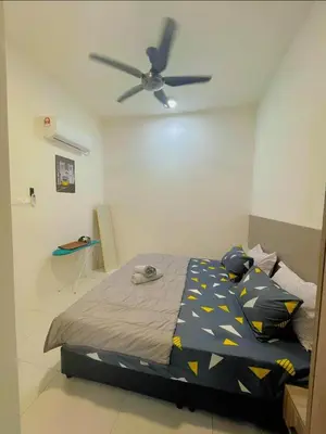a bedroom with a bed with a ceiling fan at Hidden Plan Homestay in Kepala Batas