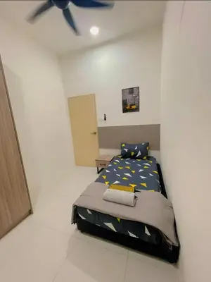 a bedroom with a bed and a ceiling fan at Hidden Plan Homestay in Kepala Batas