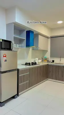 a kitchen with wooden cabinets and a kitchen area at Hidden Plan Homestay in Kepala Batas