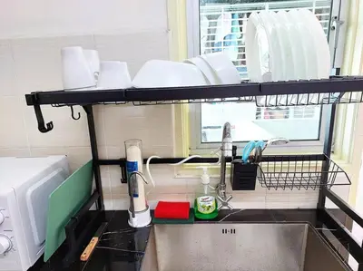 a kitchen counter with a sink and a shelf above it at Tur -Weeks Stay-3rooms Private House in Bayan Lepas