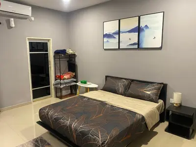 a bedroom with a bed and a picture on the wall at Pintu A Damai D'Sawah in Kampong Parit Fourteen