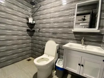 a bathroom with a toilet and a sink at Pintu A Damai D'Sawah in Kampong Parit Fourteen