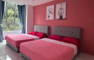 two beds in a bedroom with red walls at FY Friends at Emerald Avenue Brinchang in Tanah Rata