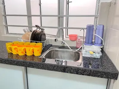a kitchen counter with a sink and some cups at FY Friends at Emerald Avenue Brinchang in Tanah Rata
