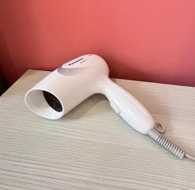 a white phone sitting on top of a bed at FY Friends at Emerald Avenue Brinchang in Tanah Rata