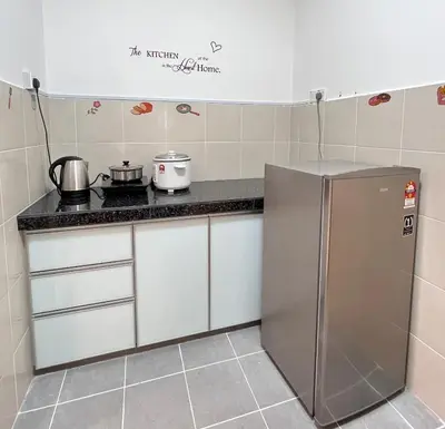 a kitchen with a stainless steel refrigerator in a room at FY Friends at Emerald Avenue Brinchang in Tanah Rata