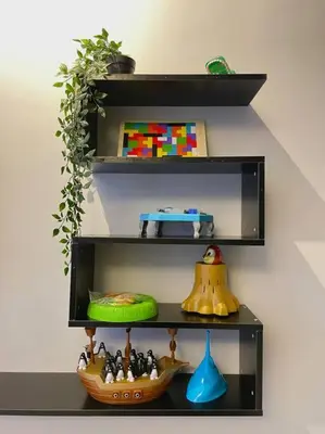 a black shelf with a bowl and toys on it at Space of Tranquility Quintet in Tanah Rata