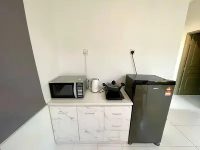 a kitchen with a microwave and a refrigerator at Space of Tranquility Quintet in Tanah Rata