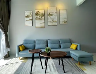 a living room with a blue couch and a table at Removed listing in Tanah Rata