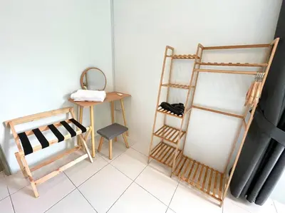 a room with a shelf and a chair and a table at Removed listing in Tanah Rata