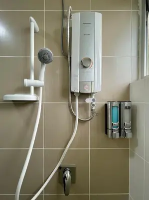a bathroom with a hair dryer on a wall at Removed listing in Tanah Rata