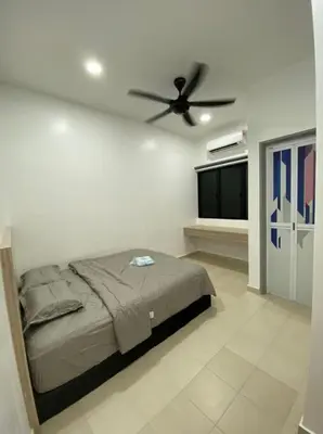 a bedroom with a bed and a ceiling fan at PANGKOR Villa 88 L26 Homestay in Kampong Sungai Udang