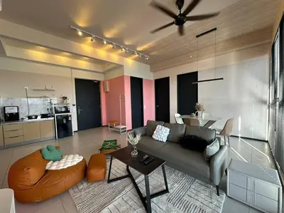 a living room with a couch and a table at Perfect KTV Set & Netflix 3 Queen Bed Seaview in Jelutong