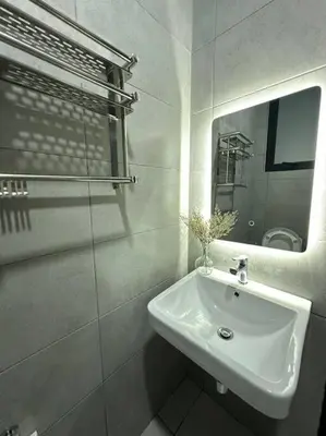 a white bathroom with a sink and a mirror at Perfect KTV Set & Netflix 3 Queen Bed Seaview in Jelutong