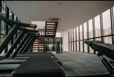 a balcony with stairs and a stair case on a building at Perfect KTV Set & Netflix 3 Queen Bed Seaview in Jelutong