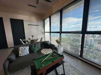 a living room with a couch and a pool table at Perfect KTV Set & Netflix 3 Queen Bed Seaview in Jelutong