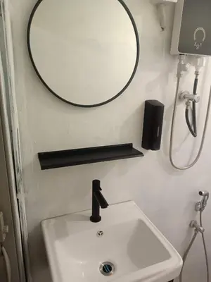 a bathroom with a sink and a mirror on the wall at Jstay guesthouse in George Town