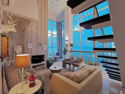 a living room with a couch and a table at Fascinating Seaview Apartment at Maritime Penang in Jelutong