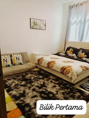 a bedroom with a bed and a couch at Meeymohd Homestay in Ipoh