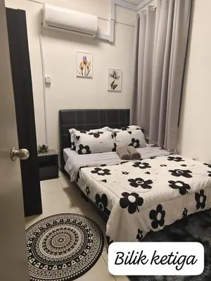 a bedroom with two beds with black and white sheets at Meeymohd Homestay in Ipoh