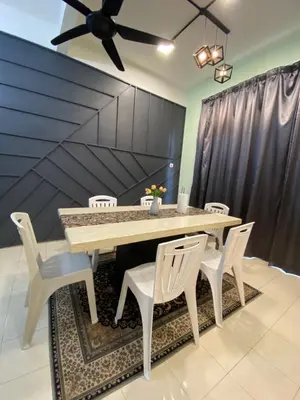 a dining room table with white chairs and a ceiling fan at Deandra Homestay- WiFi-Aircond-Dryer in Sungai Petani