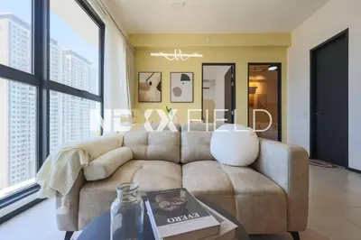 a living room with a couch and a large window at Urban Suites Penang by Nexx Field in Jelutong