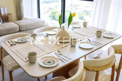 a dining room table with plates and utensils at Urban Suites Penang by Nexx Field in Jelutong