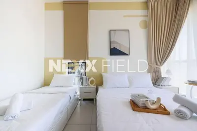 two beds sitting next to each other in a bedroom at Urban Suites Penang by Nexx Field in Jelutong